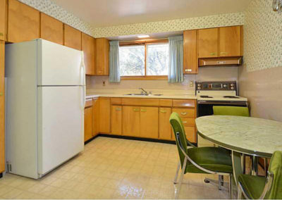Green chairs and dated wallpaper