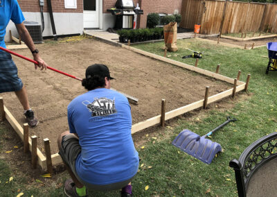Men making flat surface for concrete pour