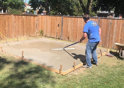 Man smoothing fresh concrete pour